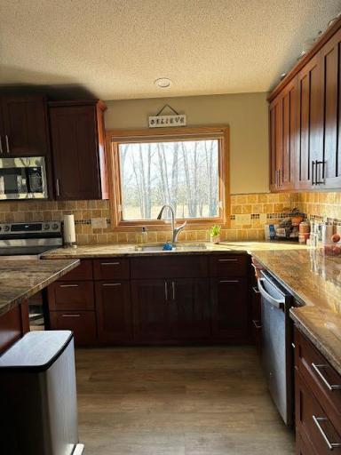 The large kitchen window faces the private backyard. The beautiful granite counter allows for plenty of space and kitchen has newer stainless steel appliances.