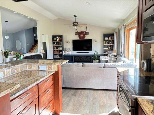The custom built kitchen is open to the living room & dining room making easy for serving and entertaining. This great room has plenty of natural light & the patio door leads to backyard.