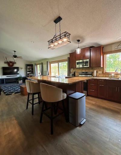 Convenient breakfast bar with granite countertops and surrounded by custom cherry cabinets.