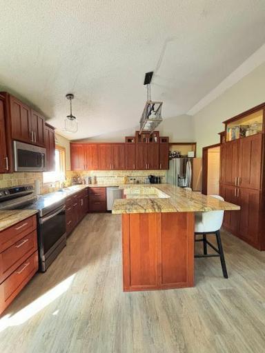 Kitchen view with custom cherry cabinets and new luxury vinyl from kitchen thru the living room.