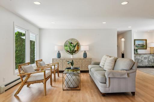 A wall of windows fill the living room with serene water views