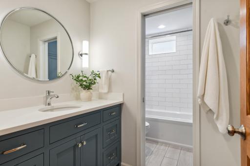 Nicely updated, lower level full bathroom with convenient two-room design.