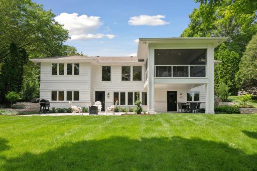 Walls of windows fill the home with water views, and multiple outdoor seating spaces