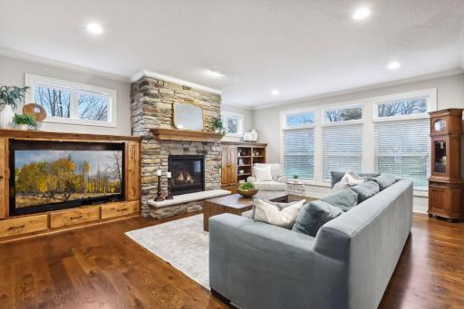 Large great room with stone surround gas fireplace. Beautiful built-in shelving and cabinets for extra storage
