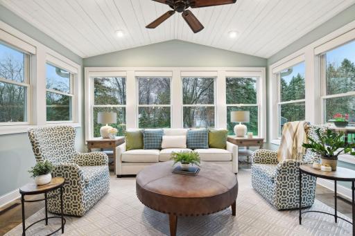 Stunning four-season porch with heated floors for extra coziness in the cooler months and custom electronic blinds