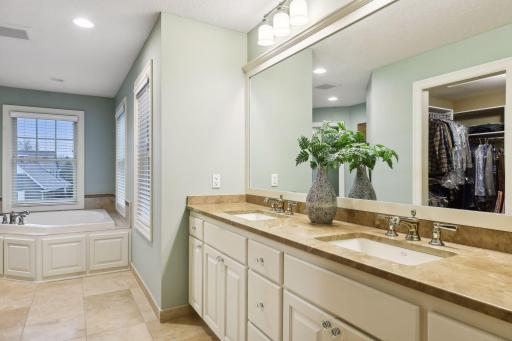 Primary bathroom includes double vanity and jetted tub
