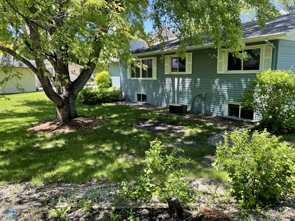 Mature trees grace the yard and boulevard