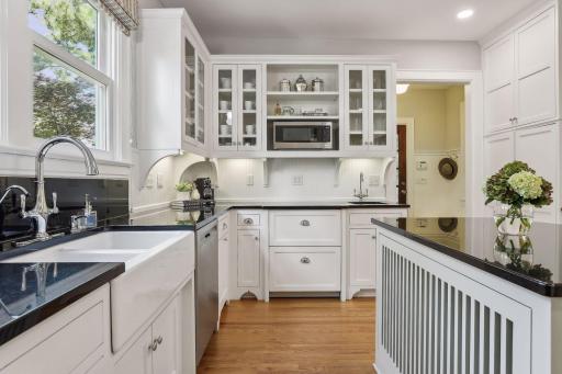 Kitchen features a center island, Viking range, Sub-Zero refrigerator, additional prep sink and original hardwood floors.