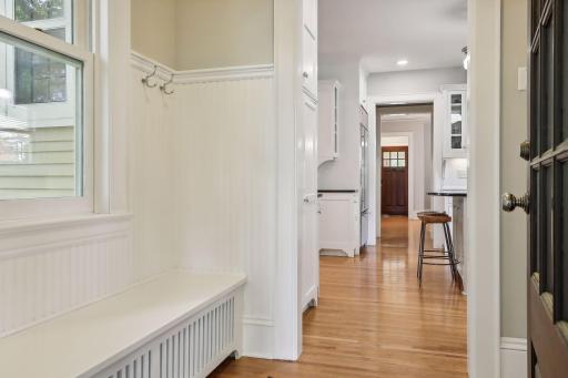 Back mudroom space leading to the kitchen and across from the powder room.