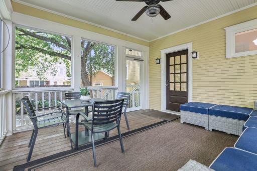 Screen porch has plenty of space for relaxing on an outdoor sofa or dining!
