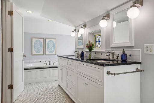 Ensuite private primary bathroom with heated tile floors, large soaking tub and separate shower. Beautiful tile, double sinks and a water closet.