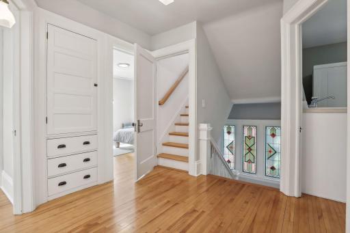 Check out this stunning staircase, built-ins and gorgeous stained glass windows!
