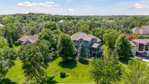 Surrounded by towering trees, this home offers a spacious yard that enjoys privacy.
