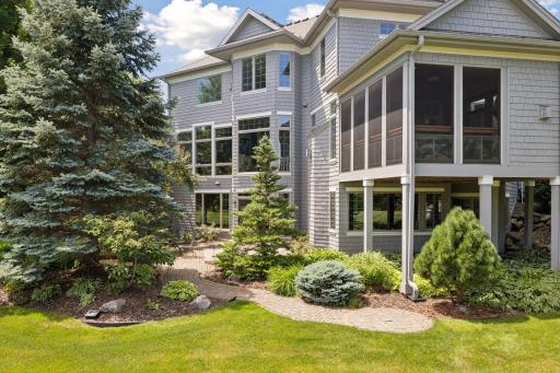Professionally landscaped with custom paver patios, mature trees and shrubs, you'll enjoy the outdoor living spaces.