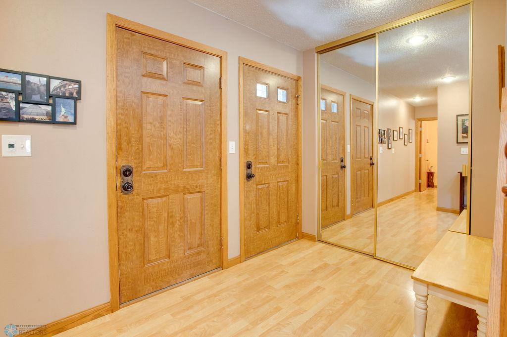 Foyer features coat closet and door to garage