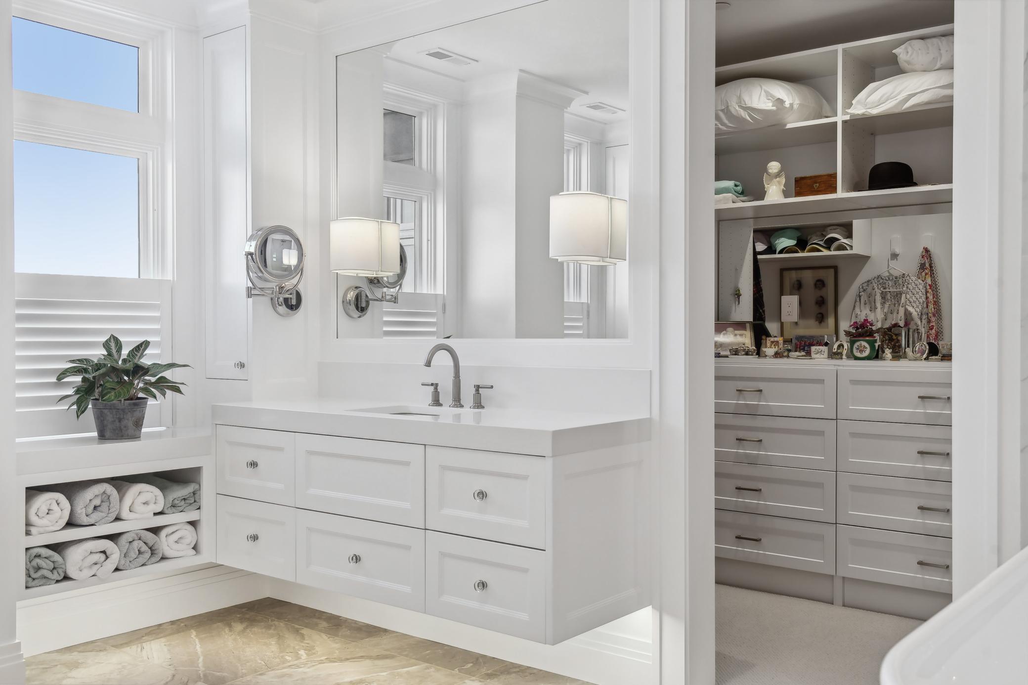 The meticulously designed walk in closet combines practicality with elegance. Thoughtfully placed hanging rods and built in cabinetry will keep you well organized.