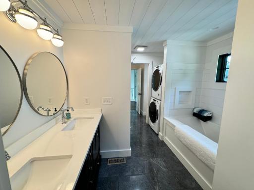 Bathroom with double sinks, soaker tub, laundry, and heated tile floors - located in the second wing