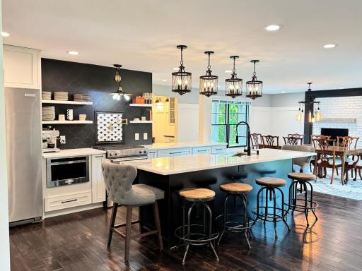 Custom tile feature with a gold pot-filler and gas range