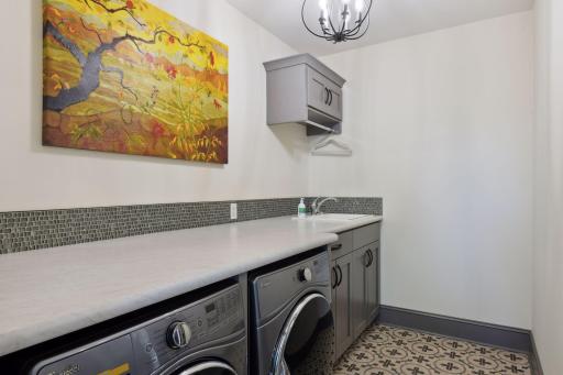 Main level laundry room with convenient access from both primary closet and mudroom.