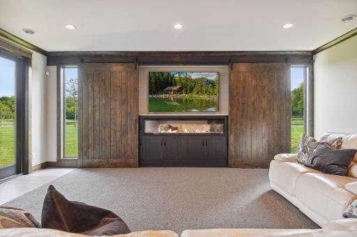 Thoughtful barn doors open to cover windows while watching tv or close to hide media center.