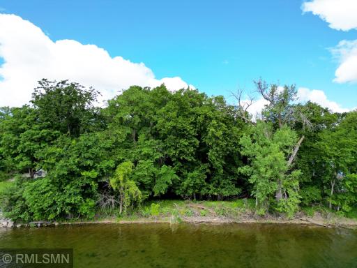 A view from the water as you see a gentle slope at waters edge providing the ideal elevation for lake property.