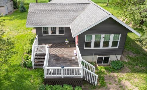 The north side of the home boasts this large deck added in 2022 - you can find yourself immersed nature with views of the large yard