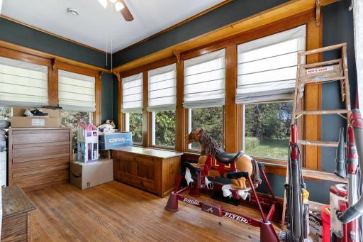 The sun room boasts surrounding windows and access to the side deck