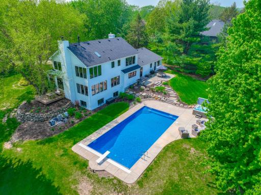 Escape to this serene retreat with a majestic park like yard on over 3 acres of wooded privacy!