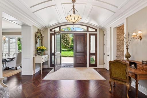 Double door entry into herringbone pattern wood flooring