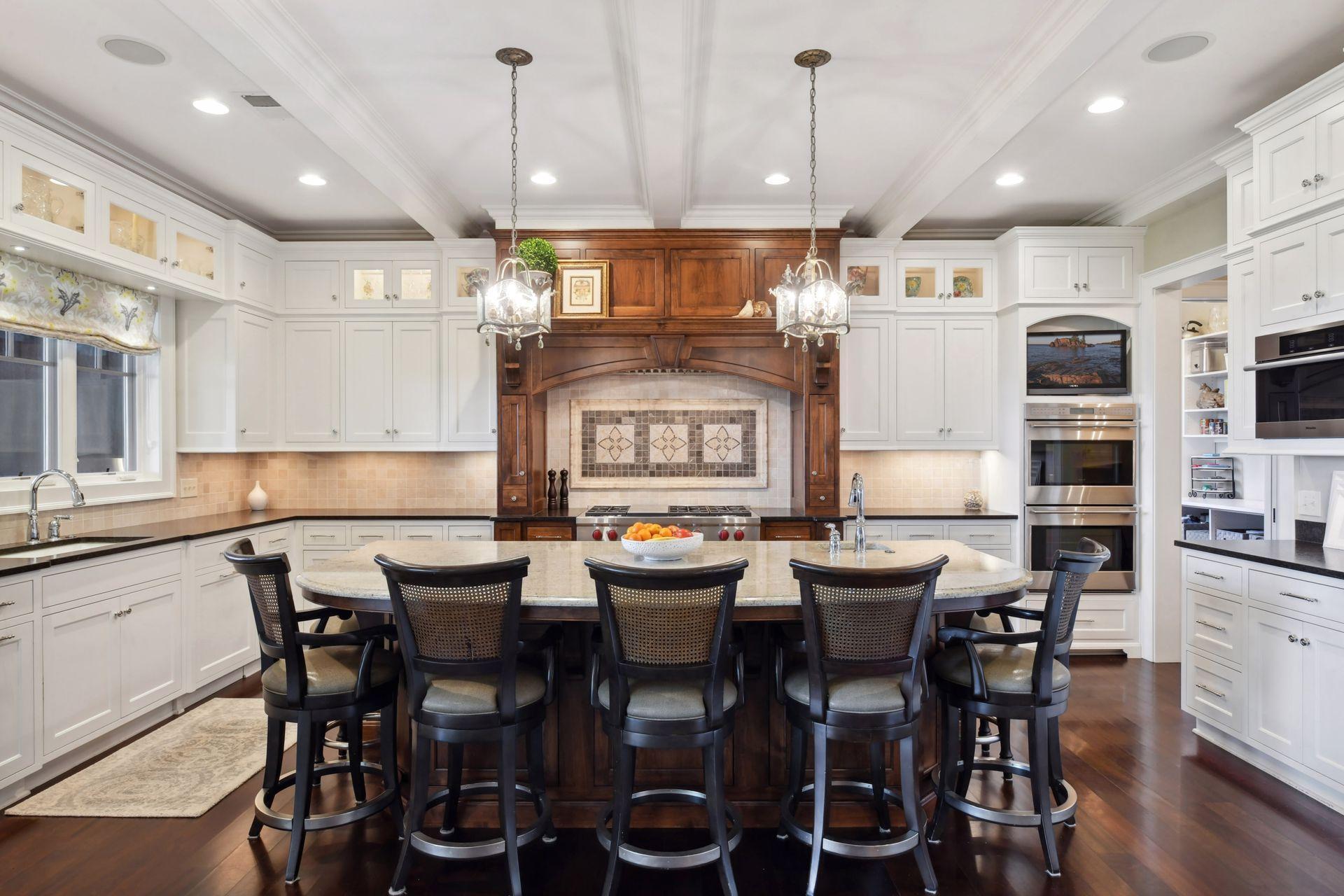 Stunning lighting in cabinet and over island, double wall over