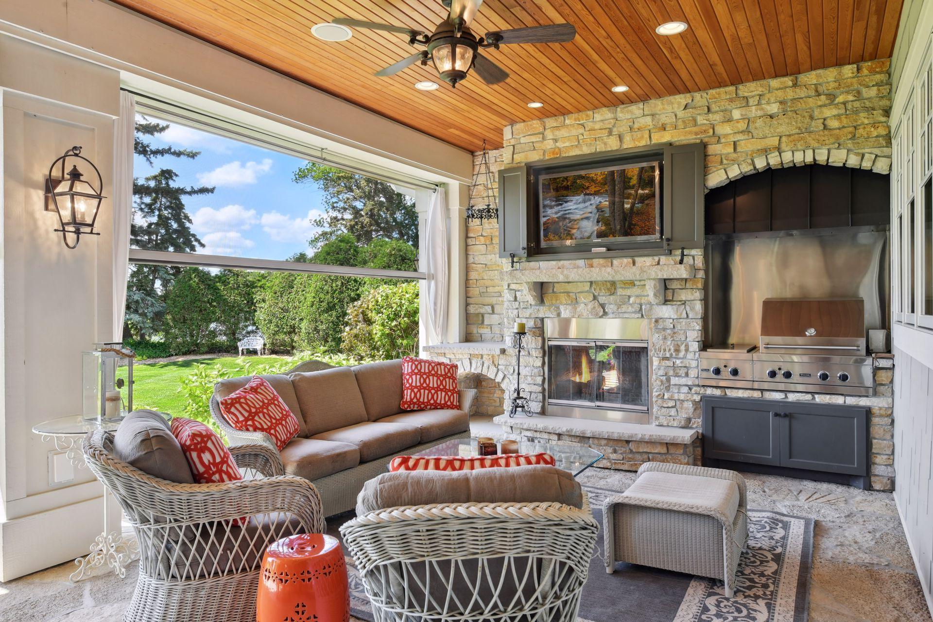 Outdoor room with wood burning fireplace, viking gas grill, phantom screens, TV viewing