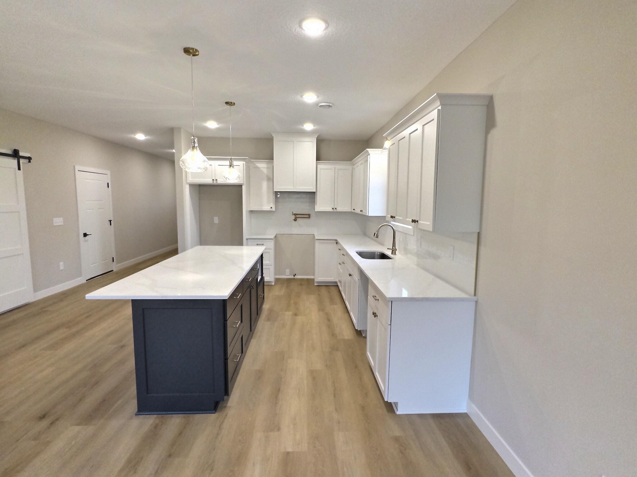 The grand center island is located perfectly for both the kitchen work station and entertaining your guests. You will love the openness of this area of the home.