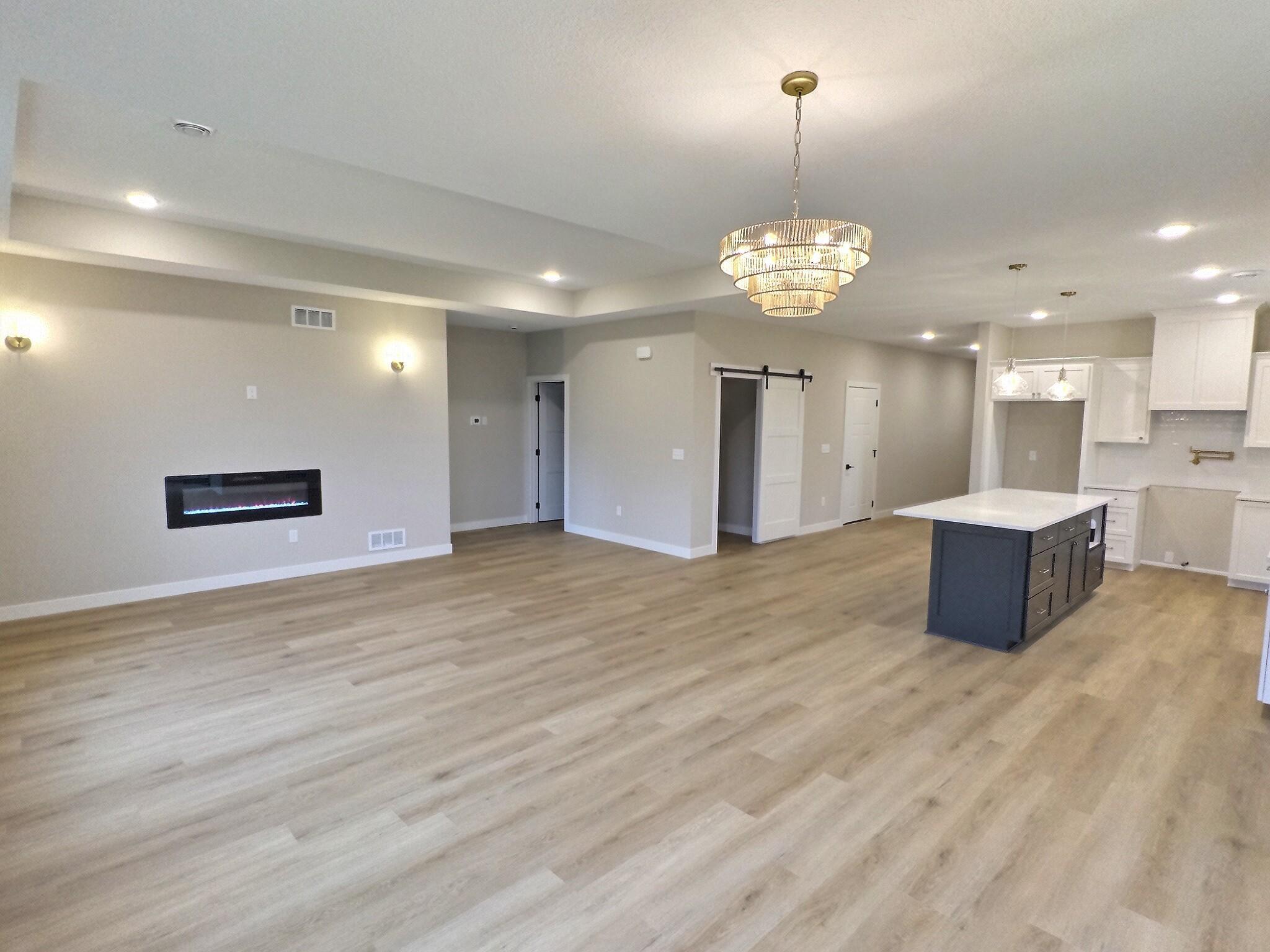 Inside, the open-concept floor plan creates a seamless flow between spacious living, dining, and kitchen areas, ideal for both everyday living and entertaining guests.