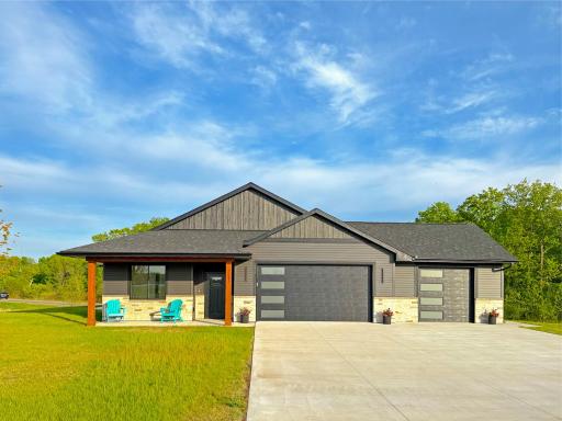 The modern color scheme blends wonderfully in the development. The sprinkler system and lawn seeding has been completed. The concrete driveway complements the oversized garage.