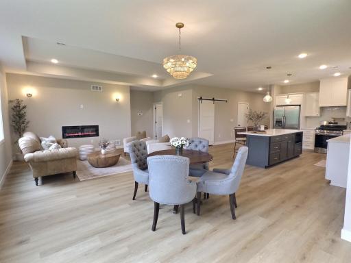 Inside, the open-concept floor plan creates a seamless flow between spacious living, dining, and kitchen areas, ideal for both everyday living and entertaining guests.