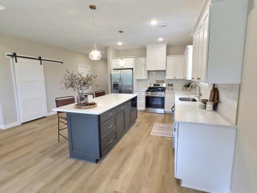 The grand center island is located perfectly for both the kitchen work station and entertaining your guests. You will love the openness of this area of the home.