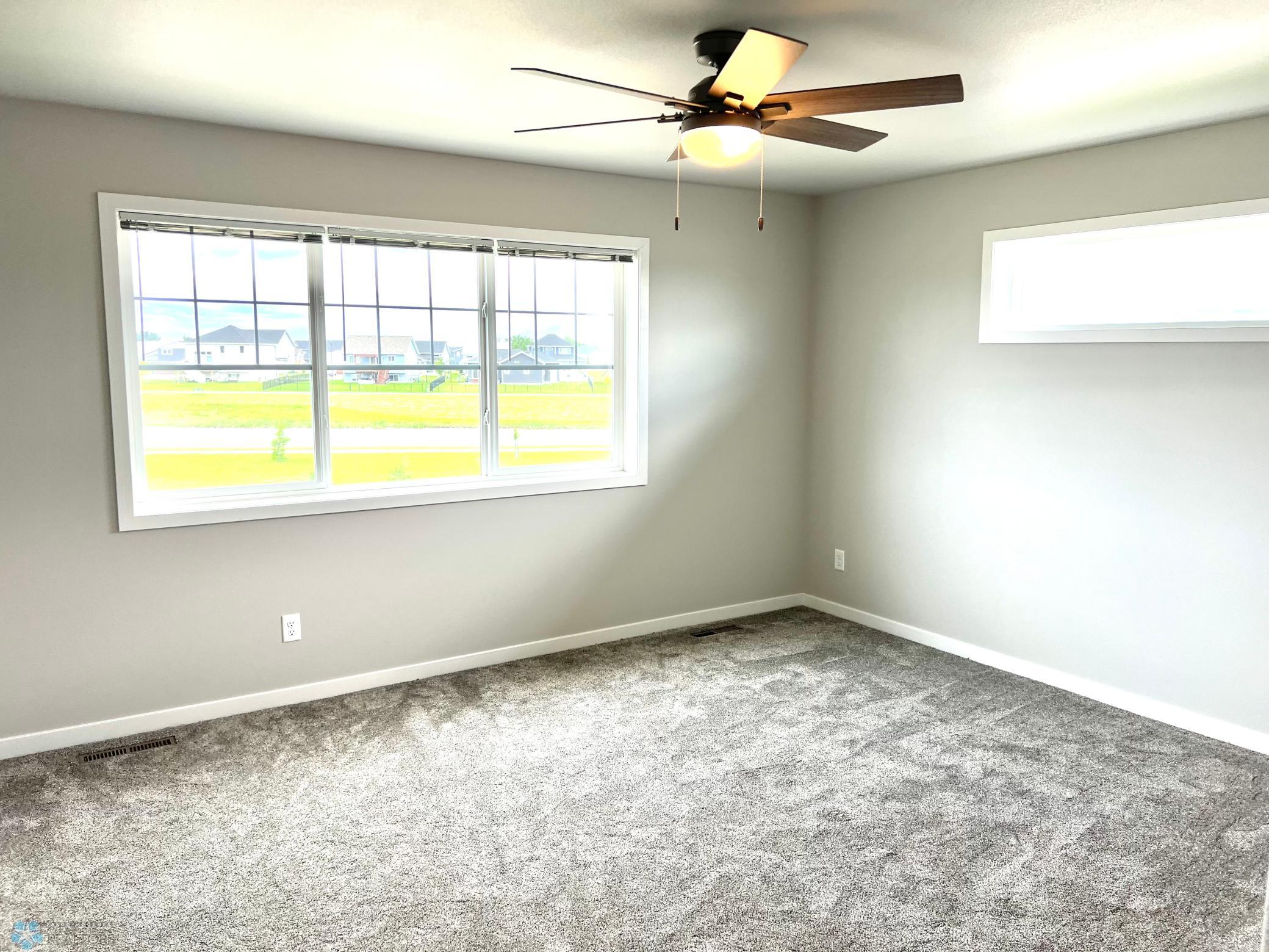 Primary bedroom with view of pond