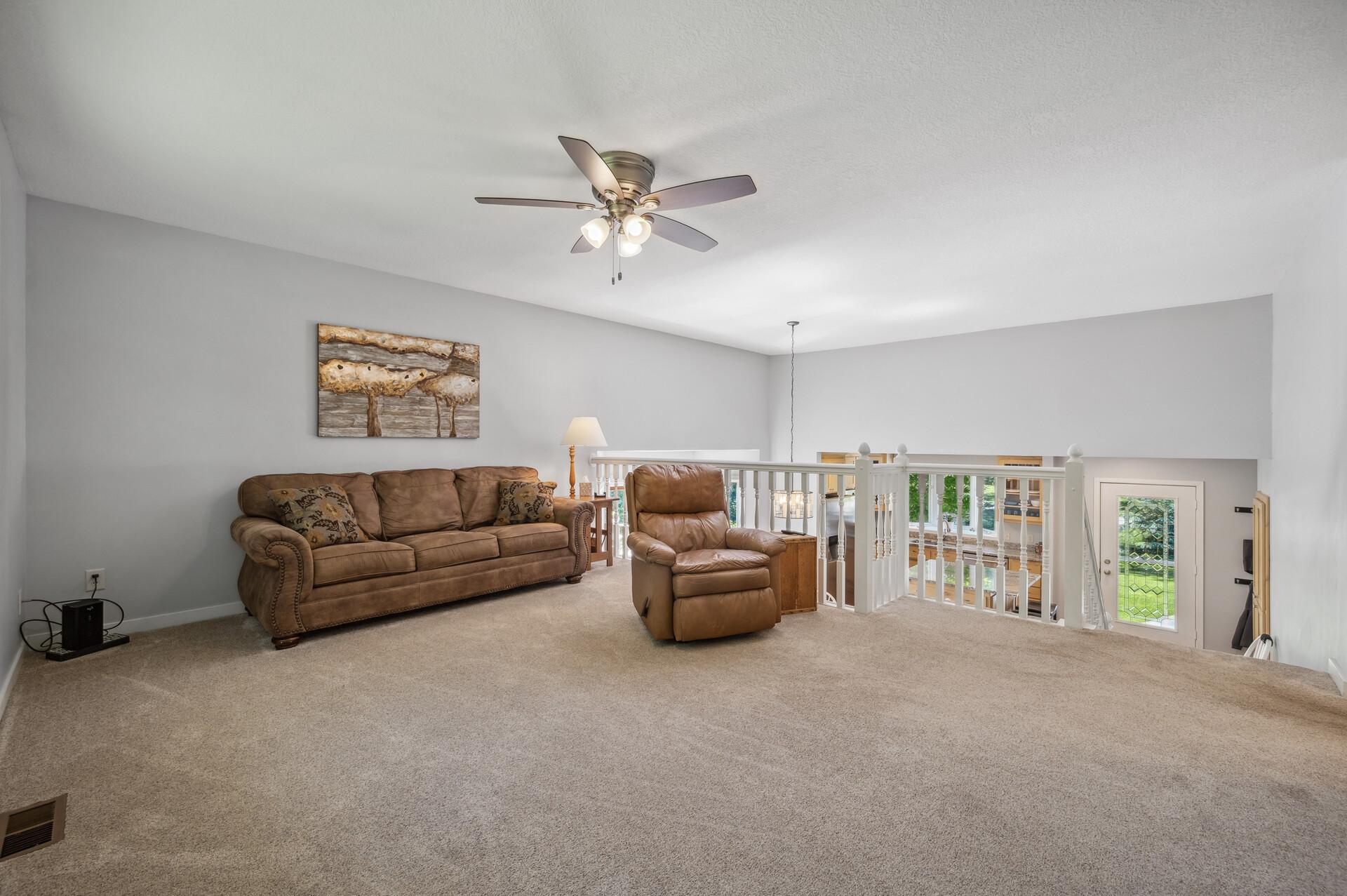 This upper level has a great living area with a ceiling fan