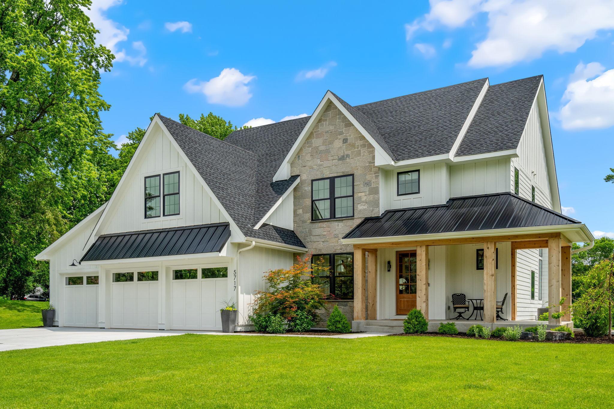 The inviting front porch, perfect for enjoying a morning coffee or evening relaxation, is equipped with recessed lighting and built-in speakers, creating a welcoming ambiance.