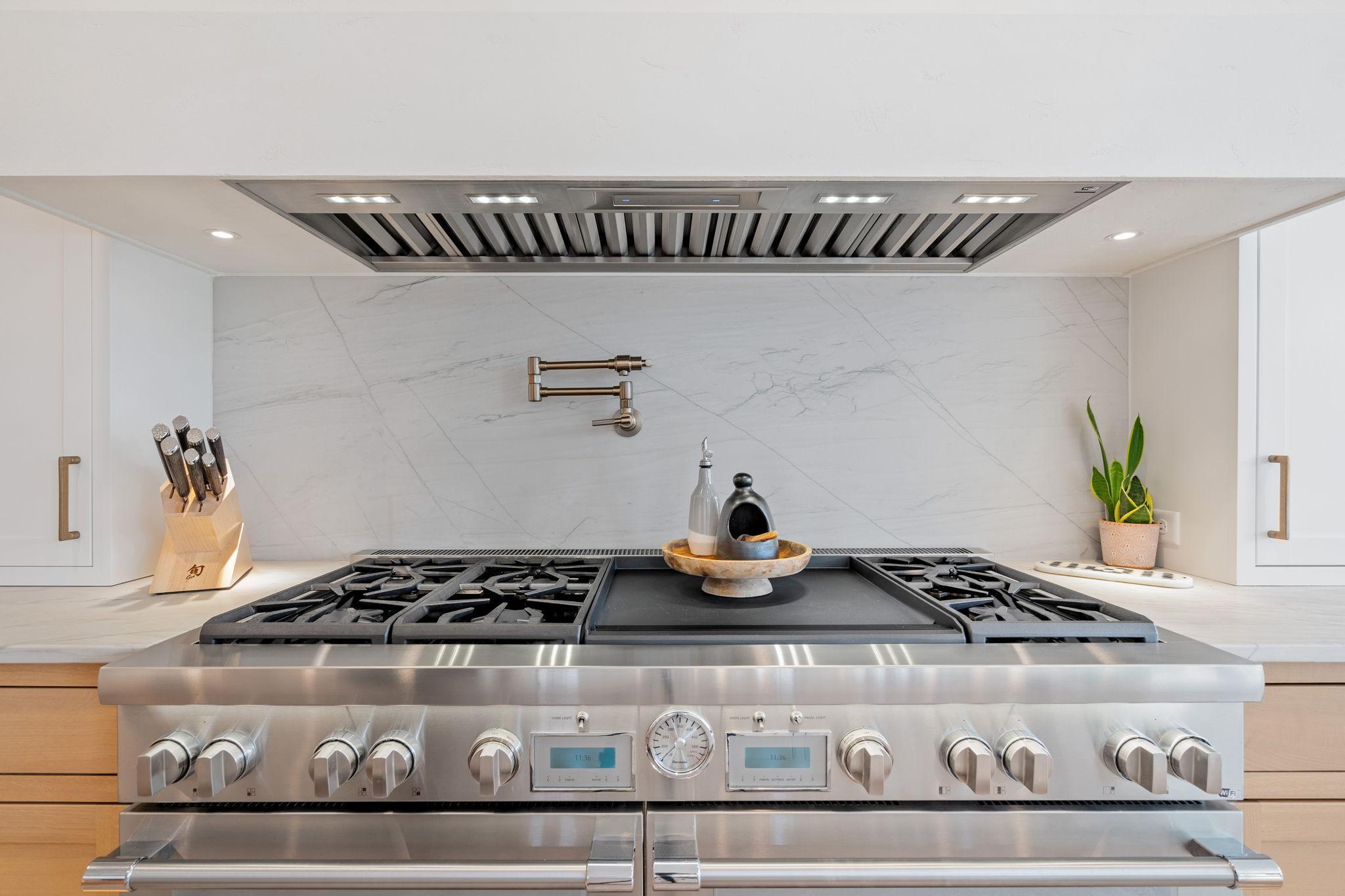 Thermador 60" gas range with a built-in griddle, perfect for culinary enthusiasts.