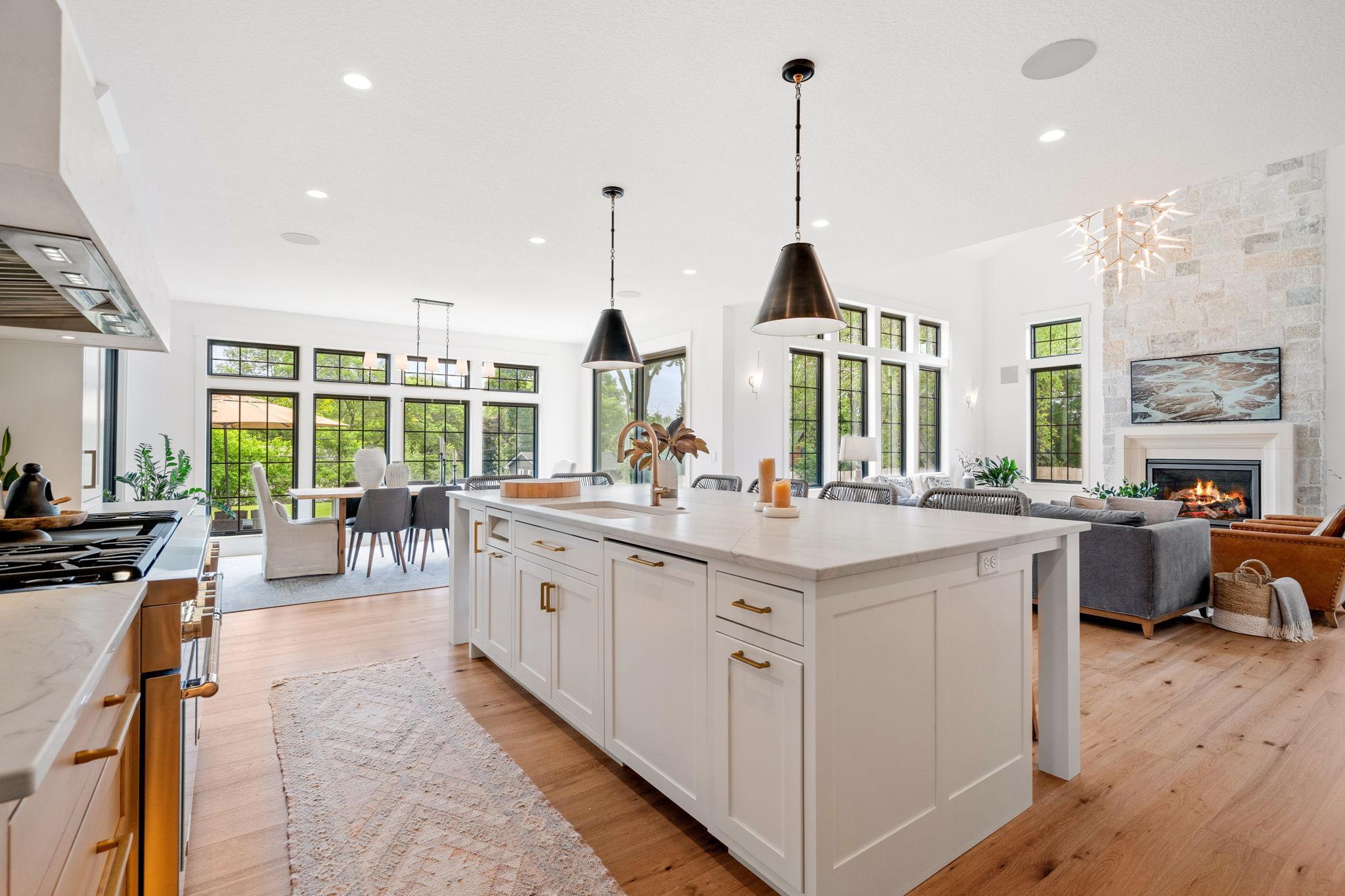 A Quartzite leather-finish island countertop serves as the centerpiece of the kitchen.