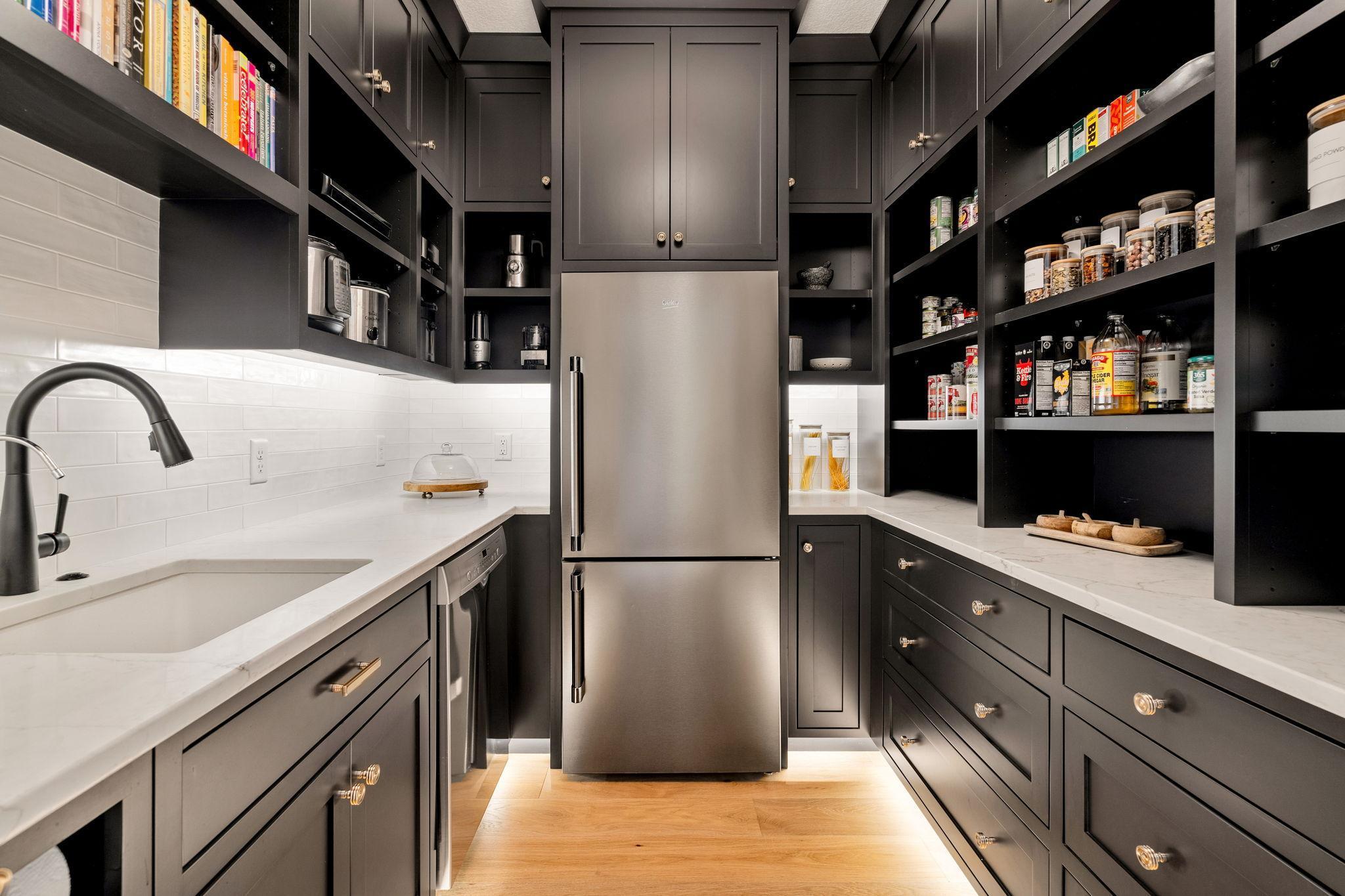 Equipped with a Bosch dishwasher, full size refrigerator and prepping sink, the butler's pantry offers additional convenience for managing dishes, glassware and food prep.