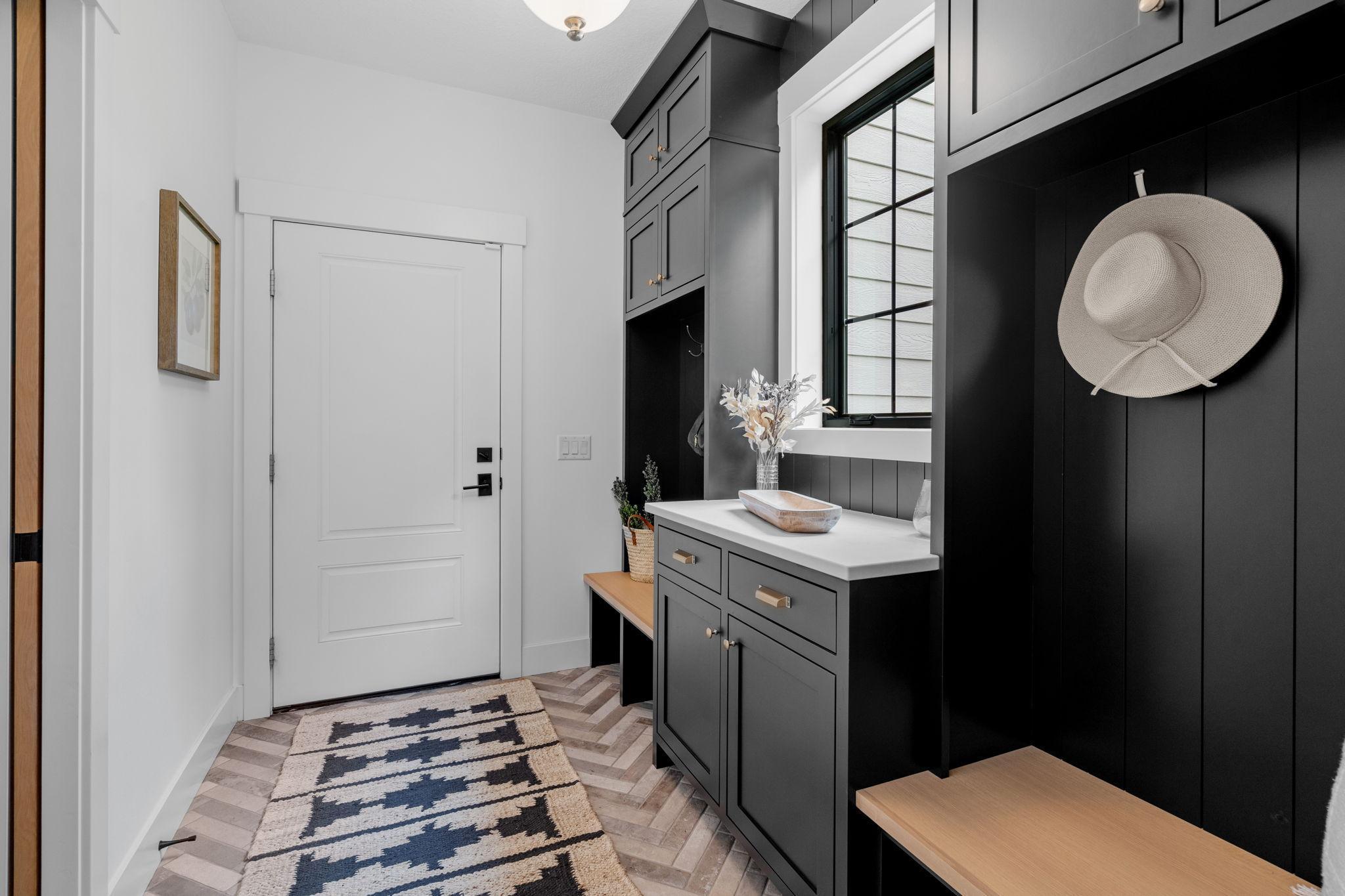 The space features built-in locker storage, offering ample space to keeping everything neatly organized and easily accessible. The tile floors are both durable and easy to clean, ideal for managing the hustle & bustle of a busy household.