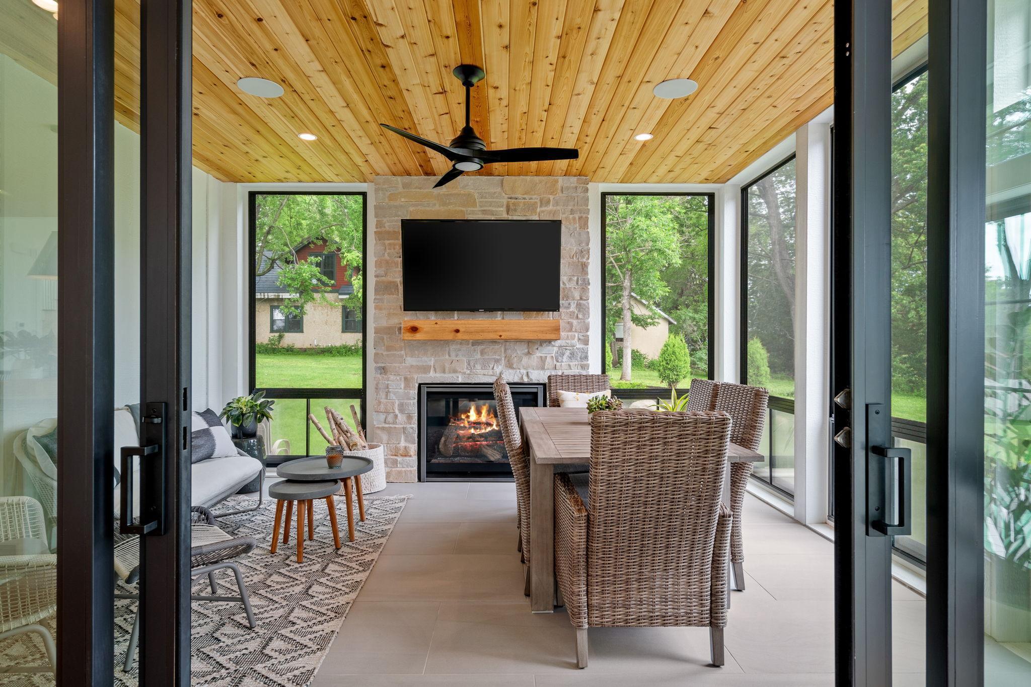 This 3-season porch is a delightful retreat that seamlessly blends comfort and elegance, making it the perfect space to enjoy the outdoors year-round.