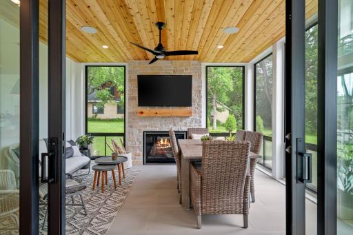 This 3-season porch is a delightful retreat that seamlessly blends comfort and elegance, making it the perfect space to enjoy the outdoors year-round.