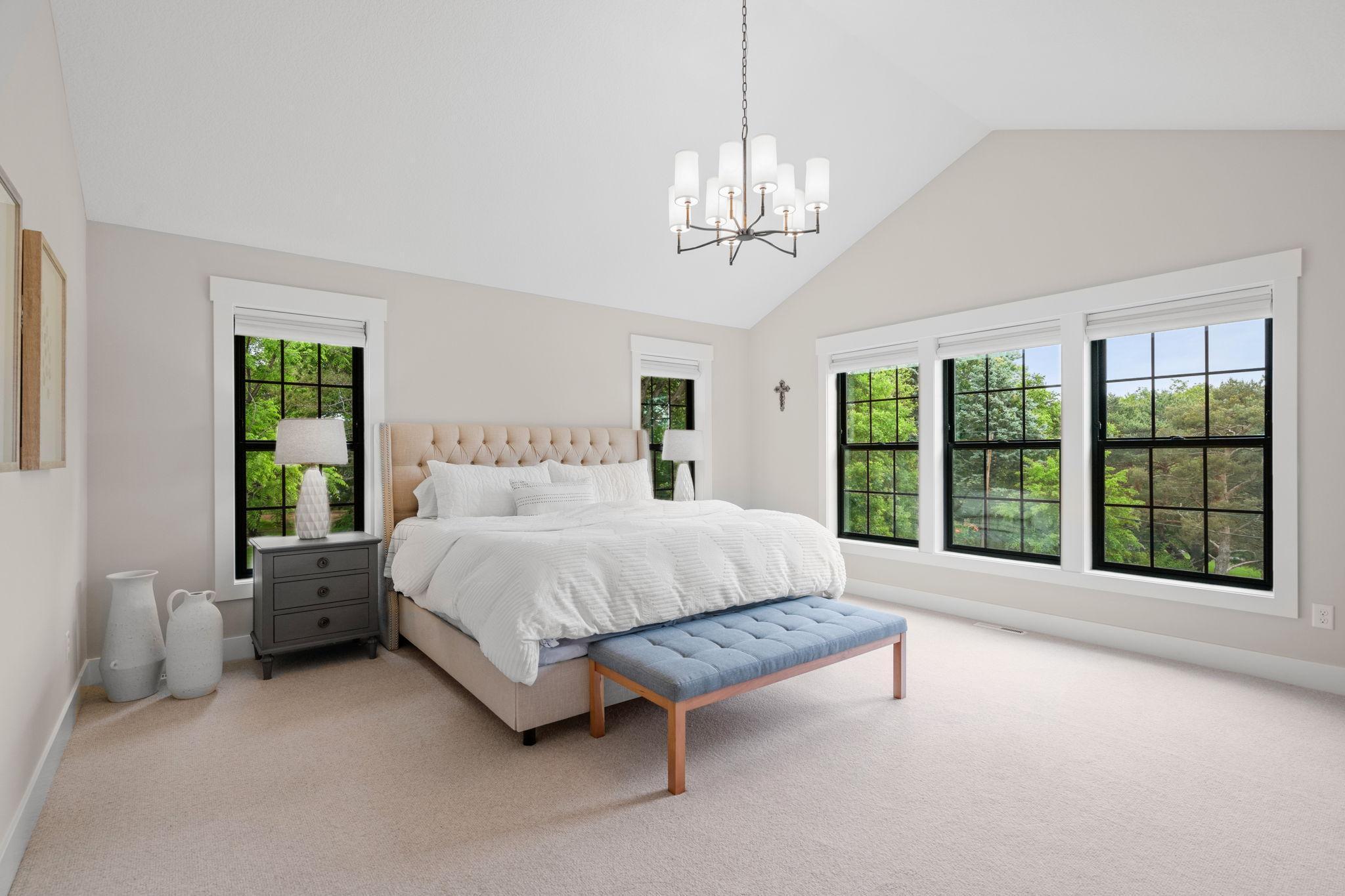 The primary bedroom is a serene retreat with impressive 11-foot vaulted ceilings that enhance the sense of space.