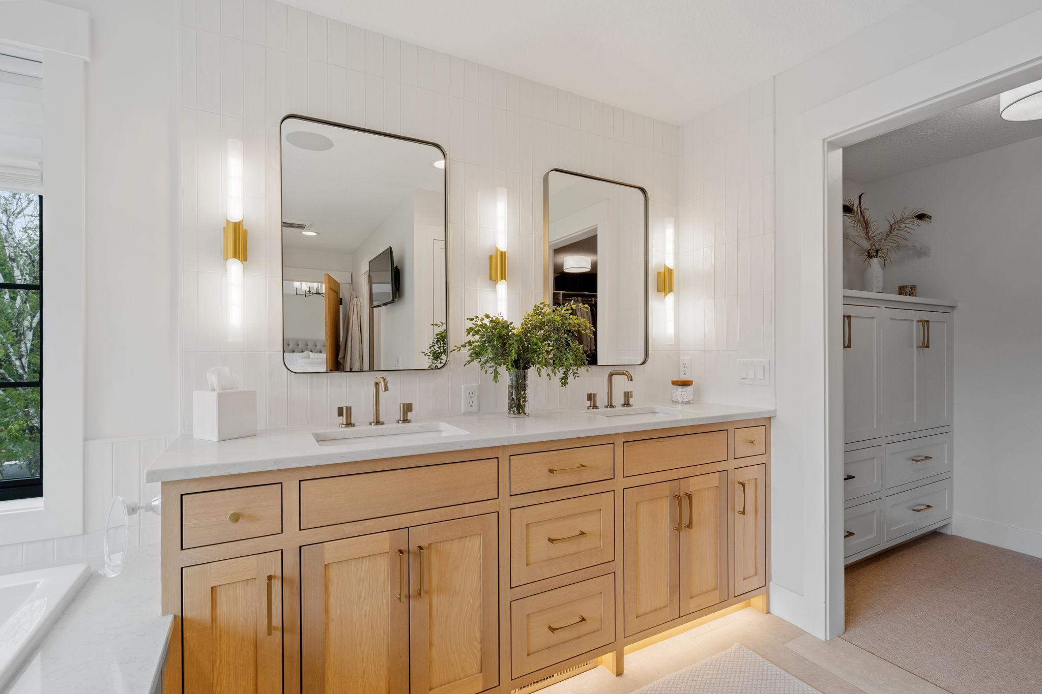 The en-suite bathroom is a true highlight, featuring a dual sink vanity with elegant Brizo faucets.