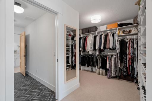 This closet seamlessly passes through to the adjacent laundry room, providing unparalleled convenience and efficiency.