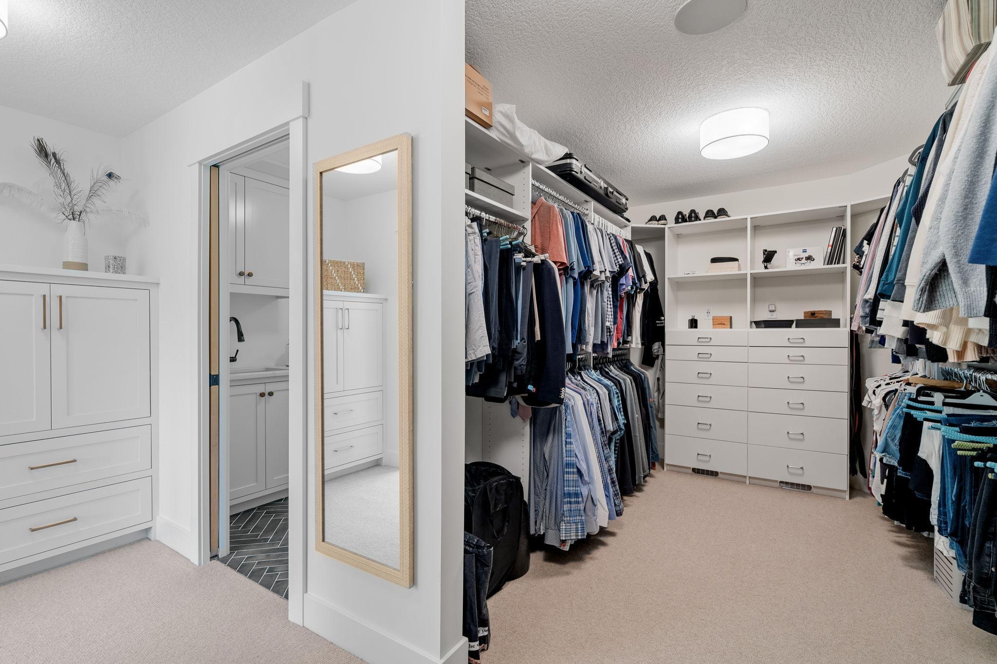 The primary bedroom also has a generously sized walk-in closet with custom built-ins, ensuring ample storage and organization.