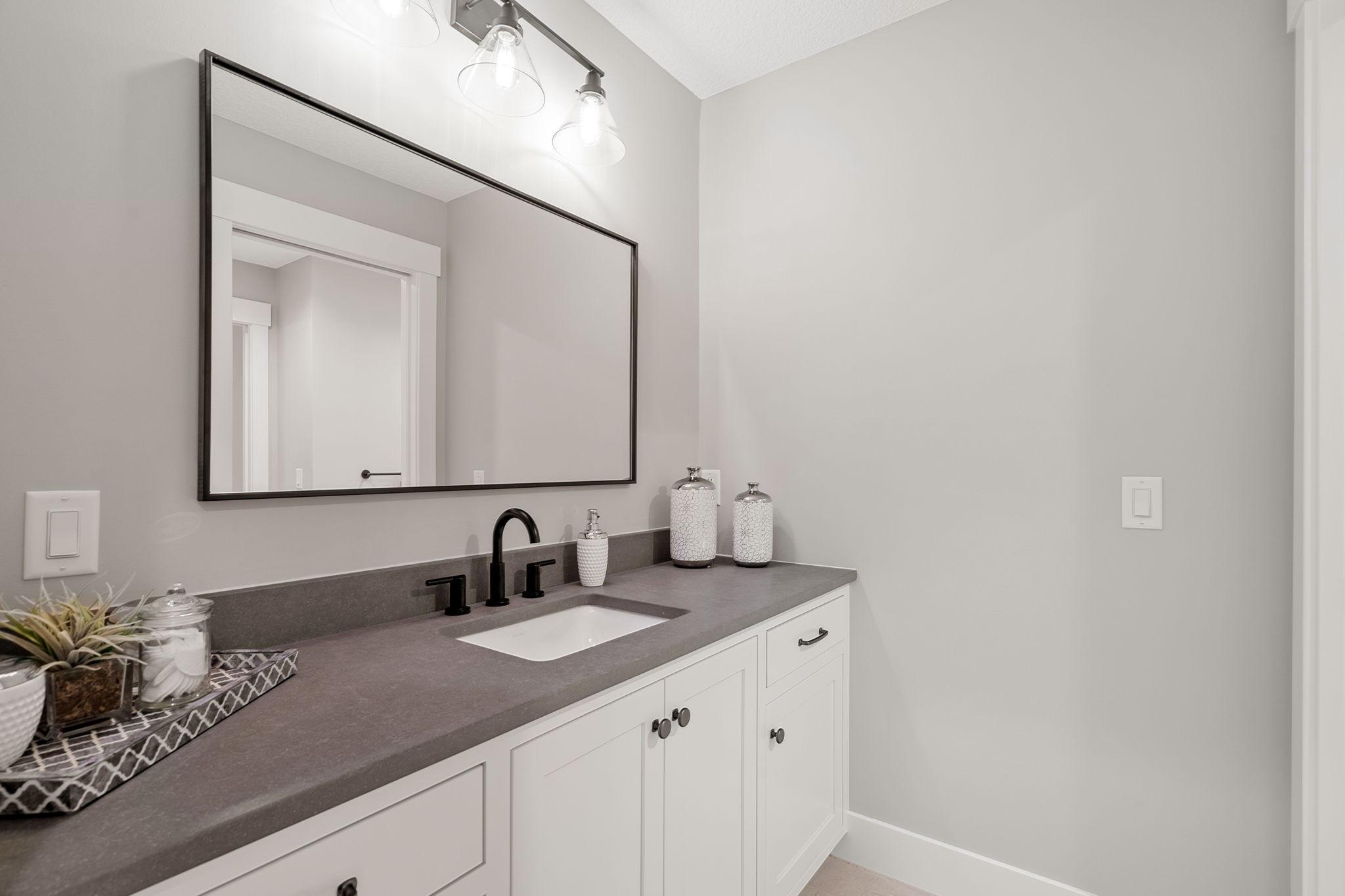 For added convenience and privacy, each bedroom boasts its own separate vanity within the Jack and Jill bathroom. Gleaming quartz countertops grace each vanity, adding a touch of opulence to the space.